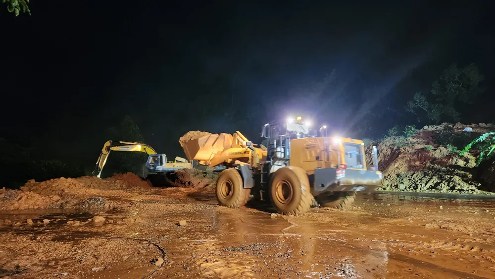 Gần 21 giờ ngày 30-7, máy móc được huy động để khẩn trương giải phóng hiện trường vụ sạt lở trên đèo Bảo Lộc