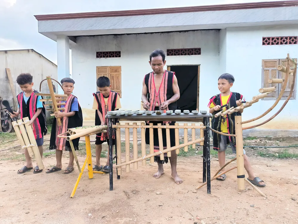 A Ngự dạy thanh thiếu niên trong xã biểu diễn nhạc cụ dân tộc. Ảnh: HP
