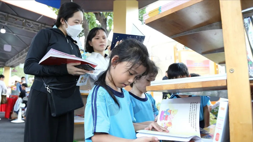 Trẻ em và người lớn tìm sách tại một hội sách ở TPHCM. Ảnh: QUỲNH YÊN