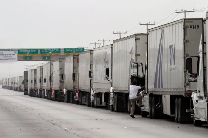 Trucks waited in a long queue for border customs control to cross into U.S. at the World Trade Bridge in Nuevo Laredo, Mexico, earlier this year. PHOTO: DANIEL BECERRIL/REUTERS