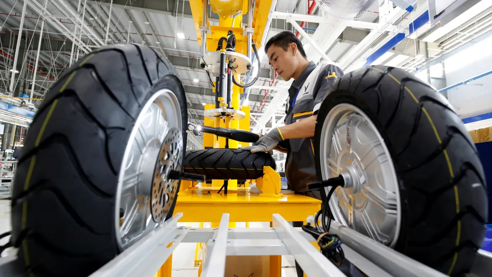 A man works at an e-scooter assembly line at a factory in Vietnam. The country is seeing a surge in Chinese companies looking to relocate operations to avoid U.S.tariffs. © Reuters