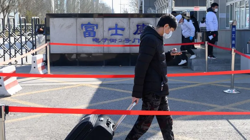 An employee enters Foxconn Science and Technology Industrial Park in Shanxi Province, China, on Feb. 22. © Reuters