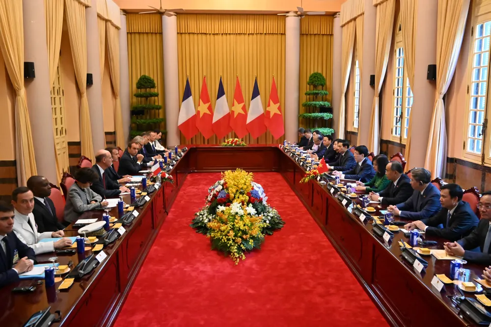 France's President Emmanuel Macron and Vietnam's President Luong Cuong sit with their delegation during a meeting at the Presidential Palace in Hanoi on May 26, 2025. PHOTO: Nhac Nguyen via Reuters