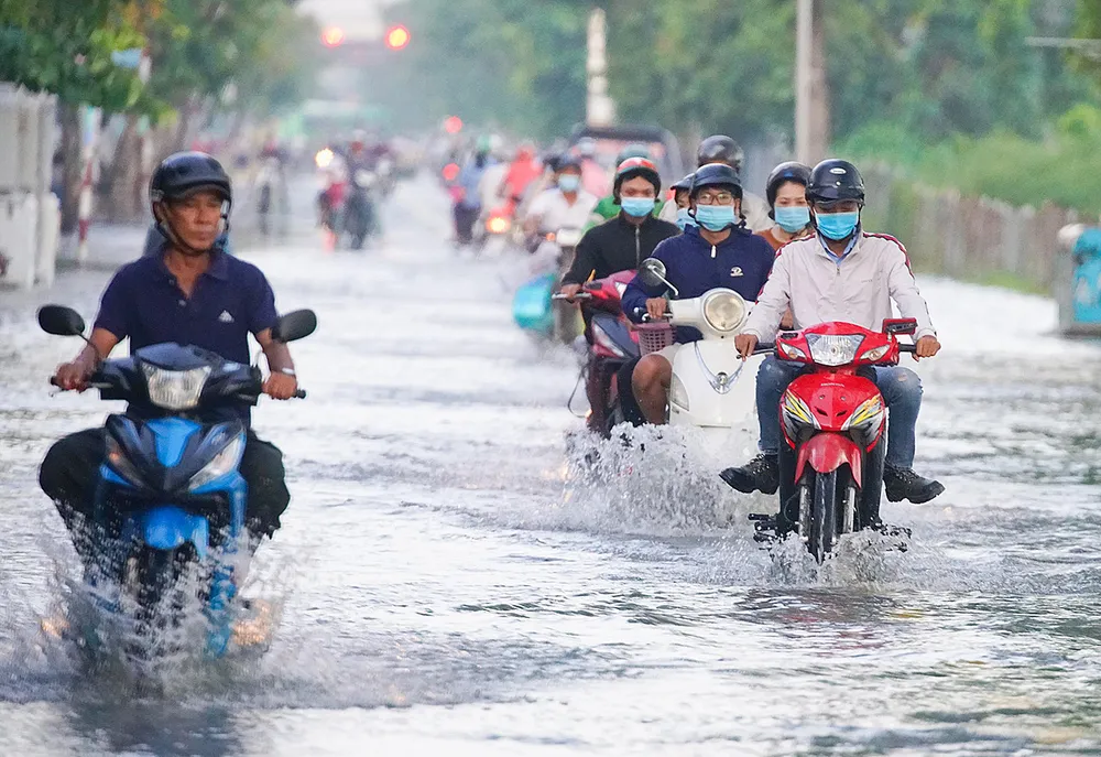 Vào tháng 10, tháng 11 âm lịch hàng năm, triều cường thường gây ngập đường Trần Xuân Soạn (quận 7, TPHCM). Ảnh: HOÀNG HÙNG