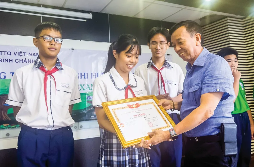 Ông David Dương - Chủ tịch HĐQT kiêm Tổng giám đốc Công ty California Waste Solutions Hoa Kỳ và Công ty TNHH xử lý chất thải Việt Nam trao thưởng cho các em đoạt giải