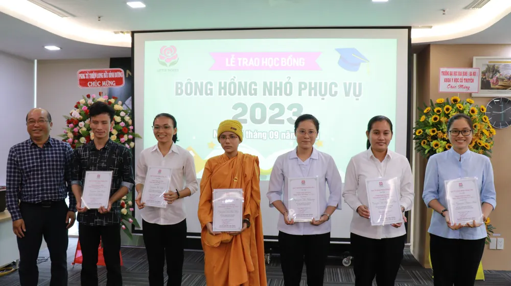 ThS. KTS. Từ Phú Đức (Trưởng khoa Thiết kế nghệ thuật Trường Đại học Hoa Sen) trao Giấy chứng nhận học bổng “Bông Hồng Nhỏ Phục Vụ” cho các sinh viên
