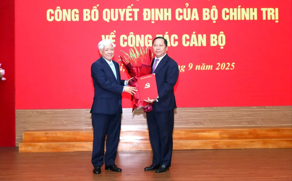 Đồng chí Đỗ Văn Chiến, Bí thư Đảng ủy MTTQ, các đoàn thể Trung ương (trái) trao Quyết định cho đồng chí Nguyễn Phi Long