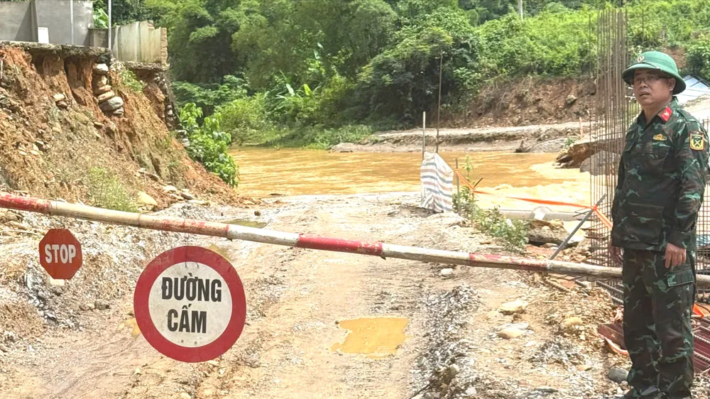 Lực lượng chức năng trực gác tại đường ngập nước sâu ở xã Tam Thái, tỉnh Nghệ An 