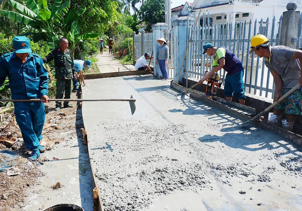 Con đường bê tông “Nhà nước và nhân dân cùng làm” ở xã Mong Thọ A (huyện Châu Thành, Kiên Giang). Ảnh: QUỐC BÌNH