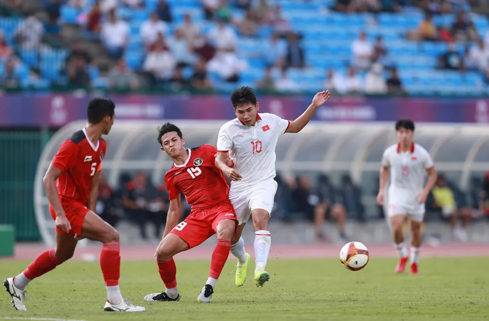 Các cầu thủ U22 Việt Nam (áo trắng) trong trận đấu với U22 Indonesia. Ảnh: DŨNG PHƯƠNG