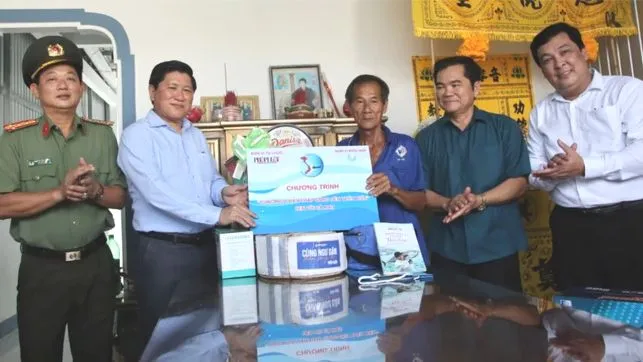 Ông Lê Văn Sử, Phó Chủ tịch UBND tỉnh Cà Mau (thứ 2 từ trái sang) trao quà đến gia đình ngư dân