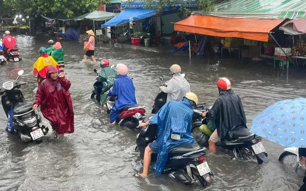 Cơn mưa lớn sáng 10/5 khiến khu vực chợ Thủ Đức ngập sâu, người dân di chuyển rất khó khăn.