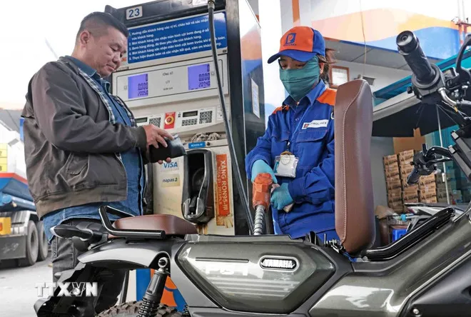 Mua, bán xăng tại điểm kinh doanh xăng dầu. (Ảnh: Trần Việt/TTXVN)