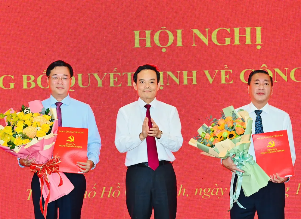 Bí thư Thành ủy TPHCM Trần Lưu Quang trao quyết định cho đồng chí Lê Quốc Phong và đồng chí Phạm Thành Kiên. Ảnh: VIỆT DŨNG