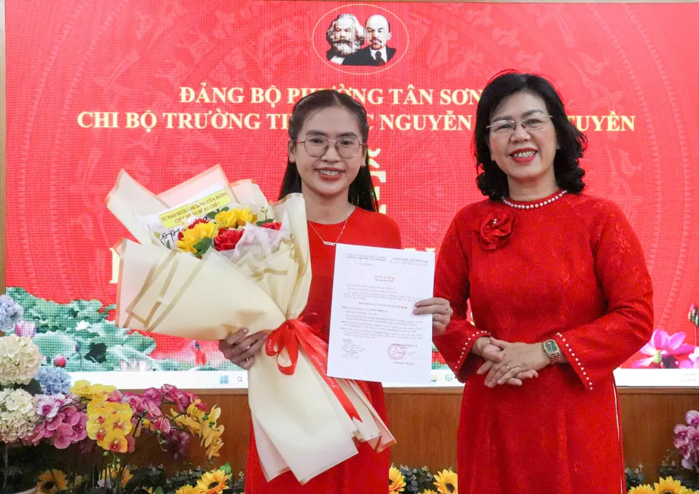 Đồng chí Trương Lê Mỹ Ngọc, Bí thư Đảng ủy phường Tân Sơn Hòa, trao Quyết định kết nạp đảng viên mới Trần Trúc Vy