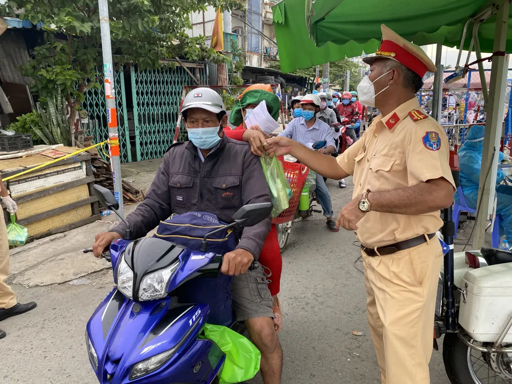 CSGT TPHCM hỗ trợ nước, sữa, khẩu trang... cho người dân trên đường về miền Tây  ảnh 3