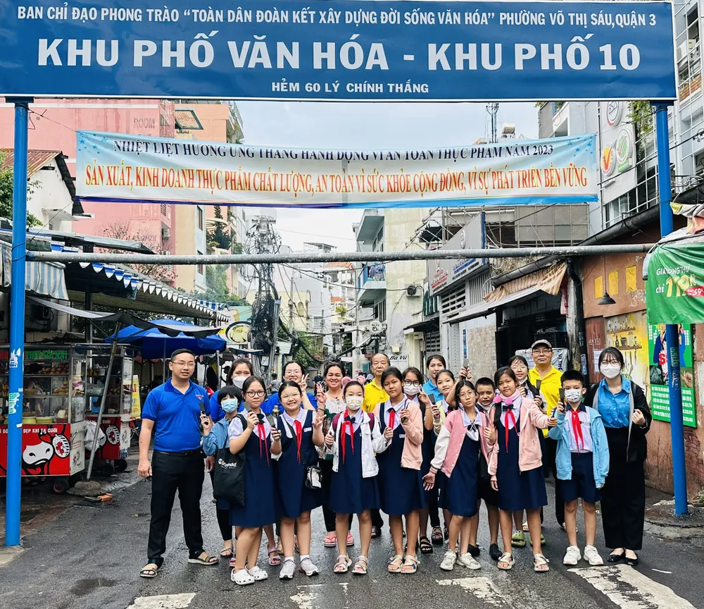 Các em học sinh tham gia bóc, xóa quảng cáo "tín dụng đen" ở từng con đường, tuyến phố. Ảnh: CHÍ THẠCH