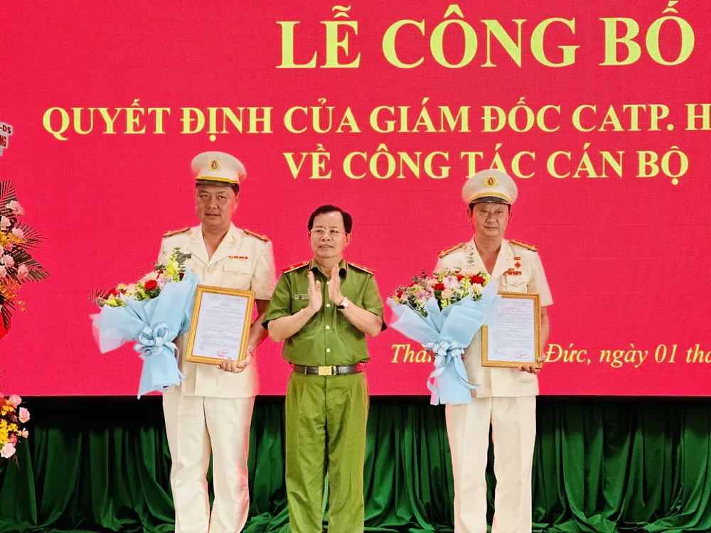 Thiếu tướng Trần Đức Tài, Phó Giám đốc Công an TPHCM trao quyết định cho 2 đồng chí. Ảnh: CHÍ THẠCH