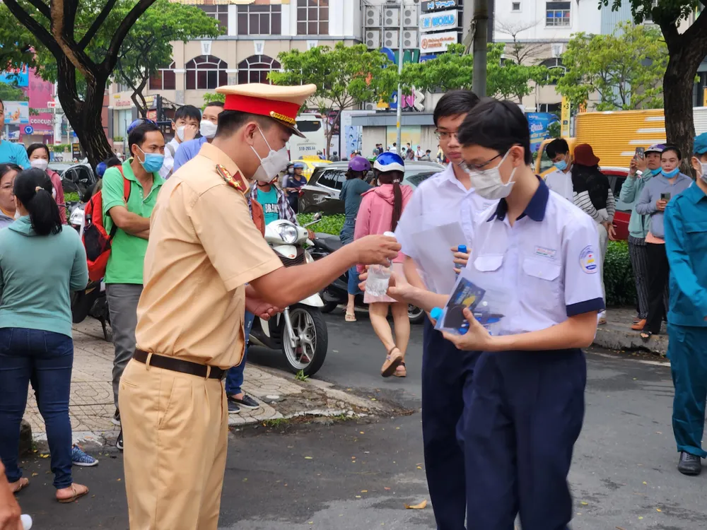 Lực lượng CSGT TPHCM phát nước cho các thí sinh