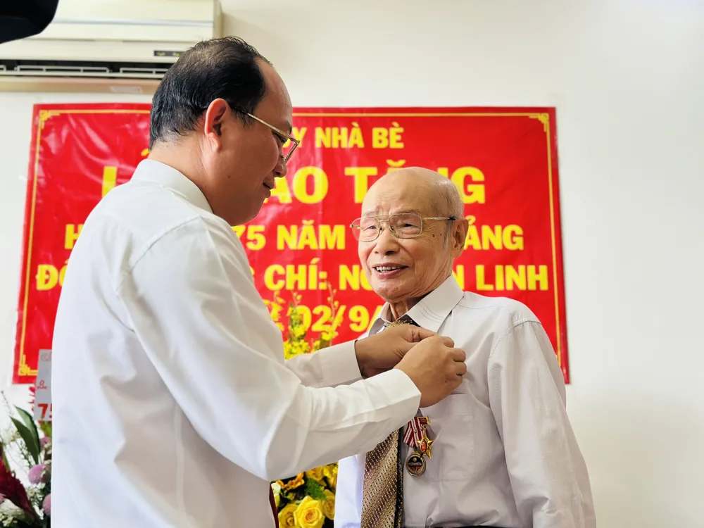 Phó Bí thư Thành ủy TPHCM Nguyễn Hồ Hải trao Huy hiệu 75 tuổi Đảng đến đồng chí Nguyễn Linh. Ảnh: CHÍ THẠCH