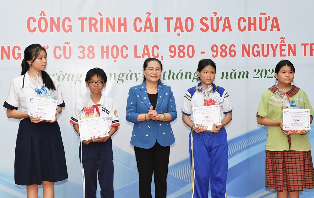 Chủ tịch HĐND TPHCM Nguyễn Thị Lệ trao tặng các phần quà cho các em học sinh có hoàn cảnh khó khăn trên địa bàn. Ảnh: VIỆT DŨNG