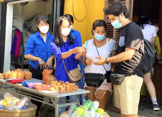 Visitors and young individuals are engaging in a program where they exchange plastic waste for gifts in Hoi An's Old Town.