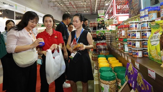 Businesses and customers explore products at the Vietfood &amp; Beverage 2023 international exhibition.