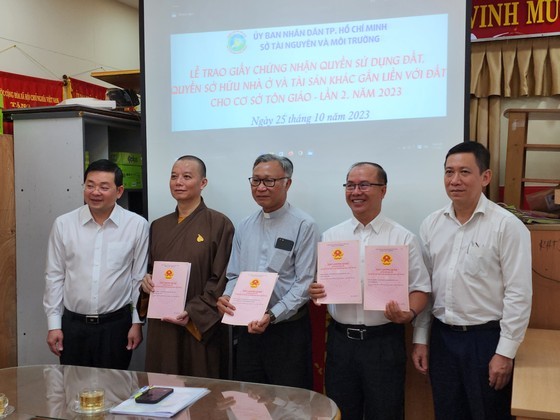 The scene at the ceremony where pink books are presented to religious institutions in HCMC