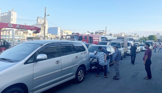 Drivers are checking their vehicles before proceeding with the registration process at the Center No.5002S.