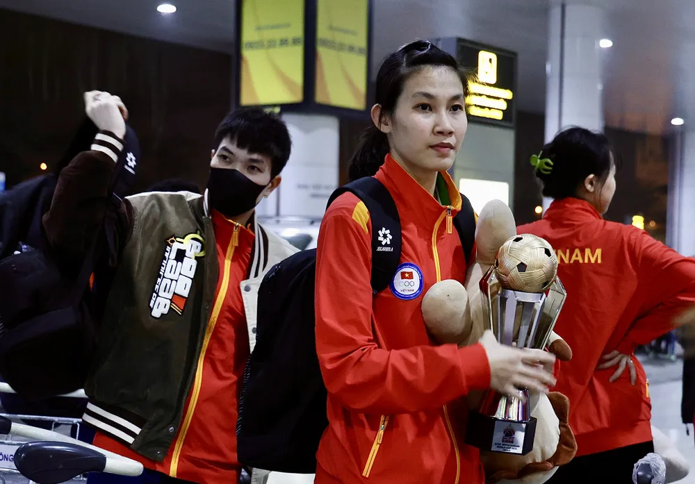 Sau chuyến bay dài các tuyển thủ cầu mây Việt Nam vui mừng khi được chào đón tại sân bay Nội bài với chiếc cúp vô địch World cup trên tay. Ảnh: Quỳnh Mai