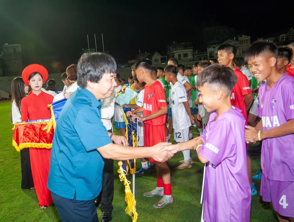 Ban tổ chức giải bắt tay động viên và trao cờ lưu niệm đến các đội dự giải.