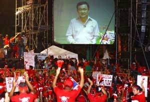Supporters of Thailand's ousted premier Thaksin Shinawatra react while listening to his speech during a demonstration at Government House in Bangkok on March 27 (AFP Photo)
