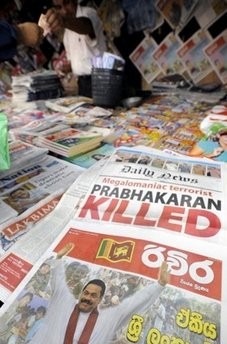 A Sri Lankan newspaper vendor displays newspapers announcing the death of Tamil Tiger leader Velupillai Prabhakaran