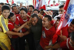 Denilson (in dark grey) embraced by Hai Phong fans on June 2