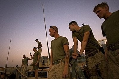 US Marines from Military Police Company 2nd Marine Division watch as dog handlers practice with their attack dogs at their forward operating base in Farah Province, southern Afghanistan.