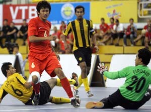 Vietnam's Bao Minh (red) approaches the Malaysia goal in their Wednesday game. Malaysia won 8-2 (Photo: SGGP)
