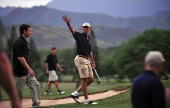 US President Barack Obama (C) waves to a crowd after playing a round of golf at the Mid Pacific Country Club in Kailua, Hawaii, on December 31, 2009. The First Family is on vacation. AFP PHOTO