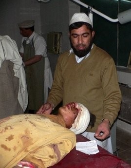 A Pakistani paramedic gives treatment to an injured suicide blast victim at a hospital in Bannu late on January 1.