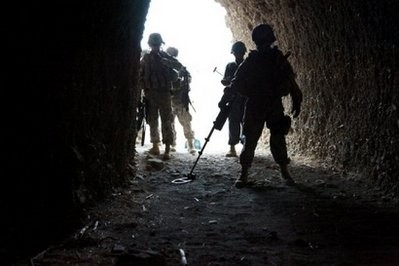 File photo shows US soldiers searching for buried enemy weapons caches in a cave near Shah Wali Zarat in Khost province.