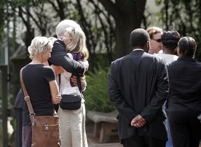 Friends and colleagues wait outside Lee Funeral Home in Nairobi, Kenya to attend funeral services Wednesday, Jan. 6, 2010 for US teacher Sharon Brown, 39, and her daughter Margaux, 1.