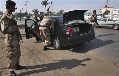 Pakistani paramilitary soldiers search a car at a checkpoint in Karachi, Pakistan on Sunday, Jan. 10, 2010.
