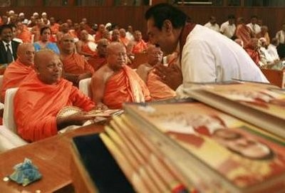Sri Lanka's President Mahinda Rajapaksa presents his election manifesto to a group of monks in Colombo January 11, 2010. (AFP Photo)