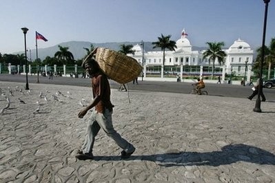 A Haitian man walks past the Presidential Palace in Port-Au-Prince, Haiti in 2006.