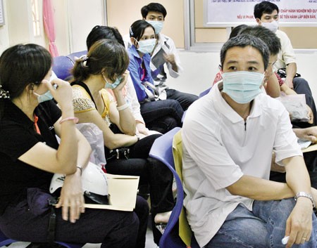 People wear face masks at a public place for fear to contract H1N1 virus. WHO is accused to exaggerate tje threat of swine flu to cause panic and sell vaccine