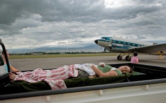 An unidentified female earthquake victim is transported by pick-up truck to the airport on January 13, 2010 in Port-Au-Prince from where she will be evacuated for treatment in another country, one day after a cataclysmic earthquake struck Haiti. More than 100,000 people are feared dead. AFP Photo