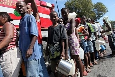 People line up to receive water from a firetruck in Port-au-Prince.
