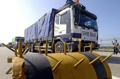 South Korean trucks carrying relief goods drive past a heavily fortified checkpoint near the inter-Korean border in Paju, north of Seoul, 2007.
