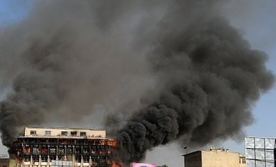 Smoke billows from a building where clashes between Taliban-linked militants and security forces occured in Kabul.