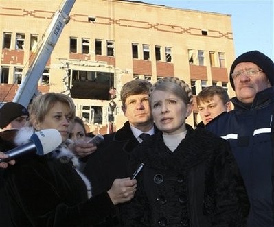 Ukraine's Prime Minister and the Presidential candidate Yulia Tymoshenko, centre, speaks to the media at a destroyed hospital building in Luhansk, Ukraine, Monday, Jan. 18, 2010.