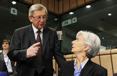 President of the Eurogroup Council, Luxembourg 's Jean-Claude Juncker (L) speaks with French Finance Minister Christine Lagarde.